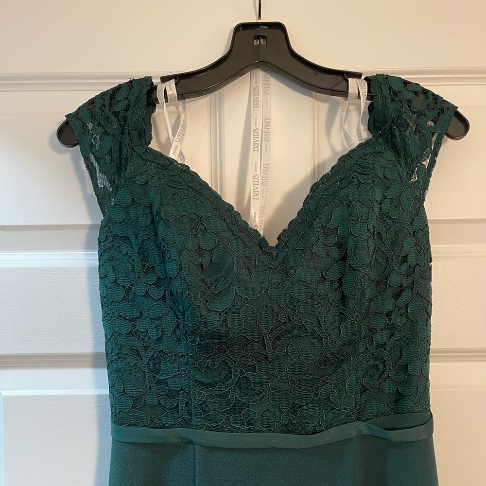 Lace crepe off-the-shoulder bridesmaid dress in David’s Bridal “Juniper”